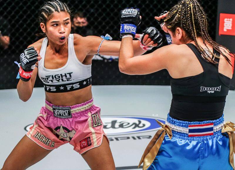 Female boxers exchanging punches in the ring